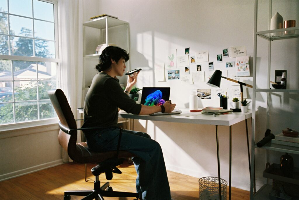Someone relieved and happy at their laptop after publishing their first blog post