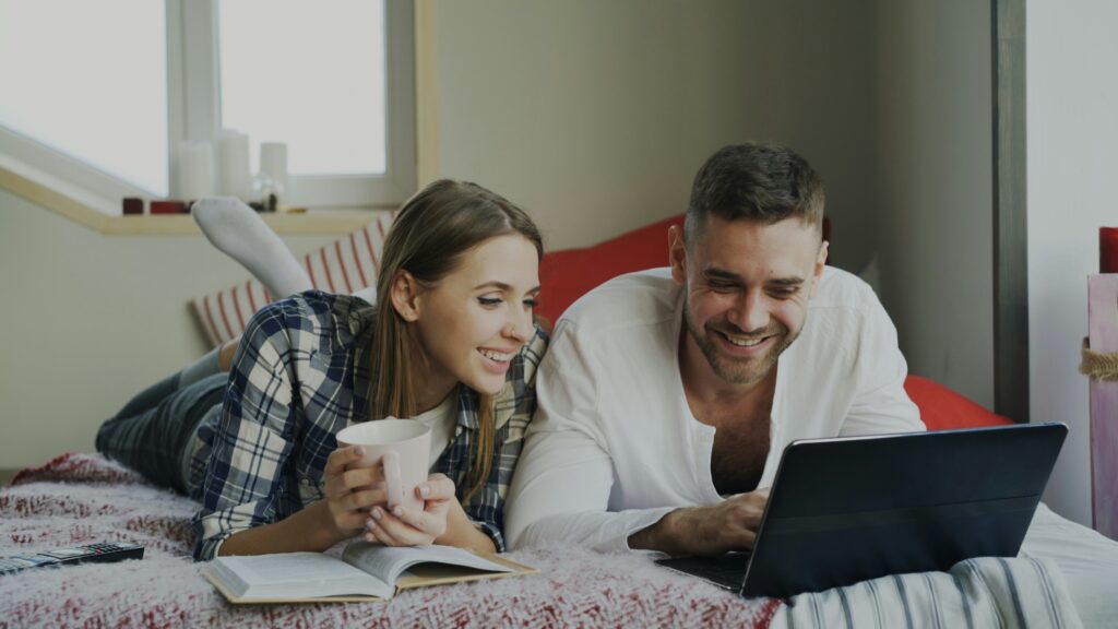 Couple reviewing their budget together on a laptop